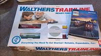 Walthers Trainline ready-to-run HO scale train set in packaging with five cars and reference book visible.