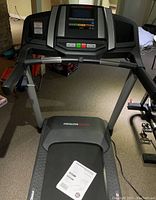 Front view of treadmill showing running deck, belt and control console