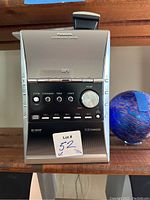 Front view of Panasonic CD stereo system main unit showing controls and 5 CD changer.