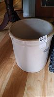 Full view of the vintage stoneware crock showing its size and form.