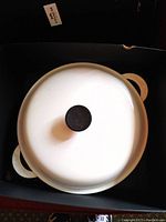 Top view of white enameled cast iron round casserole with lid