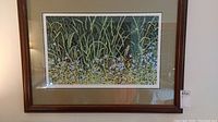 Framed numbered print showing detailed meadow edge vegetation with thin tall green grass and blue wildflowers in a brown wooden frame.