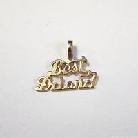 Front view of a small 10K yellow gold pendant with the inscription 'Best Friend' in connected cursive script.