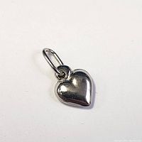 Close-up front view of the 14K white gold heart pendant showing its polished and smooth surface with attached bail.