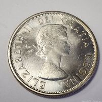Obverse side of the 1963 silver Canadian 50 cent coin showing Queen Elizabeth II profile and inscription.