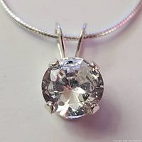 Close-up front view of the cubic zirconia pendant set in silver, attached to the silver chain.