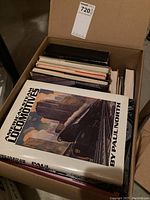 Box open showing top-down view of books with 'American Steam Locomotives' on top.