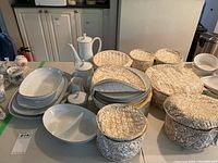 Photo showing the full assortment of dishes including bowls, plates, teapot, creamers, sugar bowls, divided dishes, and covered containers.