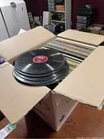Box of vintage LP and 78 RPM records showing the quantity and partly opened box.
