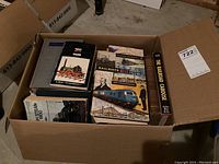Box filled tightly with books on trains and railways; visible titles include Railway Men and Locomotives, and The Railroad Caboose