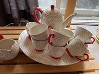 Wood & Sons teapot with lid, eight matching mugs with red handles, and oval platter for coffee service.