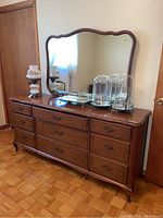 Full front view of nine-drawer dresser with mirror attached