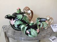 Full display of the monkey teapot set with creamer, sugar bowl on the cut glass tray