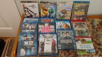 Photo showing 15 assorted PS3 games and Blu-ray movies arranged on a surface including Final Fantasy XIII, Ratchet & Clank, LittleBigPlanet 2, Kick-Ass Blu-ray, X-Men movies, Ice Age, Fight Club special edition Blu-ray, and others.