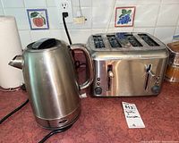 Oster electric kettle and Black & Decker 4-slice toaster on countertop