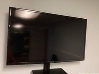 Front view of the Samsung 40 inch TV screen mounted on stand