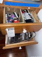 Second drawer with additional items such as packing tape and other supplies.