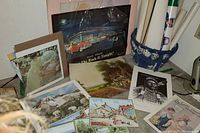 Photo of assortment of prints including wildlife scenes, vintage portraits, and a basket with rolled posters inside.