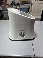 Side view showing the white Honeywell humidifier with control knob.