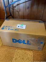 Sealed Dell branded cardboard box with handling icons and labels.