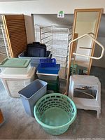 Full view of bins, hampers, step stools, mirror, and baskets grouped together