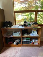 Front view of teak shelving unit showing top surface and open compartments