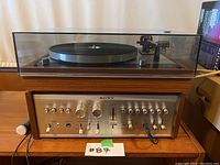 Front view of turntable and amplifier in wooden cabinet