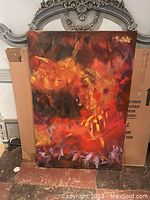 Full view of the abstract painting showing warm tones predominantly red, orange, yellow over dark background with textural brushstrokes.