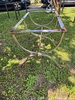 Side angle showing metal frame with brass detail and rust marks.