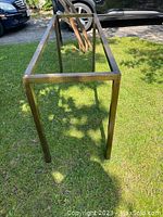 Full view of the brass tube console table frame, showing rectangular shape and four legs, no glass top.