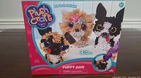 Box front showing Plush Craft Puppy Pack 3 cute projects with images of completed puppy crafts and 816 pieces count.