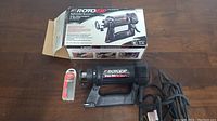 RotoZip Spiral Saw with original box and 18-piece Front Zip replacement bits set on table.