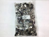 Clear plastic bag containing 100 silver vinyl and nickel-plated strap clips with black rubber tip grips, visible quantity and product label.