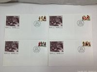 Set of five First Day Cover envelopes arranged flat showing stamps and postmarks