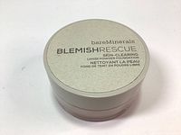 Closed container of bareMinerals Blemish Rescue Loose Powder Foundation with label on lid showing brand and product name.