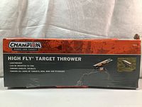 Box displaying Champion High Fly Target Thrower 40901 with product features and image.