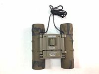 Top-down view of Safari 10x25 mini binoculars with camouflage rubber armored finish and neck strap.