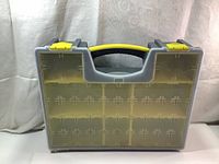 Front view of Stack-On gray plastic tool organizer with transparent lid and yellow snap locks and carrying handle.