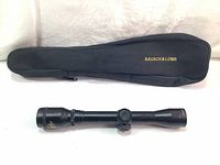 Black soft zippered scope carrying case with gold "Bausch & Lomb" text on surface.