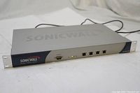 Front angle view of SonicWALL SSL-VPN 2000 device showing ports and LED indicators on metallic gray housing.