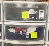 Two stacked plastic storage drawers containing mixed bicycle maintenance and cleaning supplies. Top drawer labeled 'Bike Stuff' and bottom one 'Cleaning'.