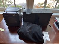 Bose SoundTouch 20 system with remote placed next to Duracraft Heat Express heater on a wooden surface.