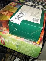 Coleman camping stove in original green box with label indicating "Coleman stove lantern"