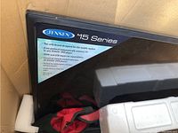 TV shown inside original packaging with styrofoam protective inserts, the label on the front bezel indicating Jensen brand and 15 Series model.