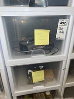 Stacked plastic drawers containing tools and accessories, with labels indicating 'tools and cables' and 'some tools'.