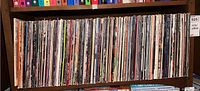 Shelf with 33 vinyl records in original sleeves