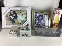 Framed 7 inch cutlery key cutting board with chef artwork, ceramic salt and pepper shakers, small ceramic container, lavender themed napkin holder with napkins, and metal geometric pattern holder.