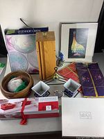 Photo showing the full assortment of wooden bowls, framed art prints, wooden box, small containers, boxed Mikasa item, and textile pieces