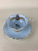 Tea cup and saucer set showing RCAF winged emblem and flag inside cup