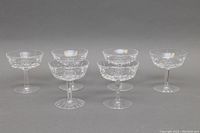 Front view of six Waterford crystal sherbet or champagne glasses arranged in a row showing intricate cut patterns.